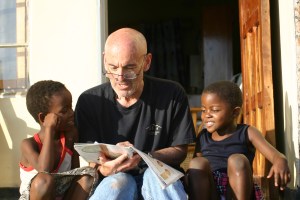 Charity and Promise with Jerrold enjoying People magazine